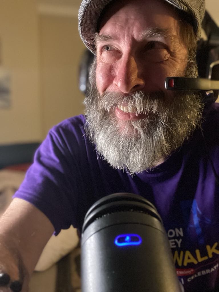 Jason Gehlert talking into a microphone during his podcast